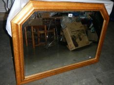 A large bevel edged mirror, approximately 106 x 75 cm.