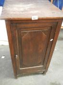 A 1920's oak cupboard with inner shelf.