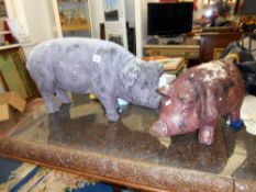 2 fibre glass pigs.