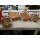 3 graduated matching pine garden trugs and a small wicker basket.