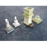 A concrete urn, 2 pedestals and assorted garden ornaments.