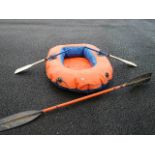 An Octopus III inflatable dinghy with oars.