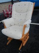 A modern rocking chair with locking arm and a Queen Anne style stool.