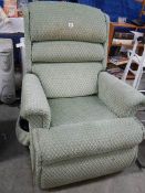 A green electric recliner chair.