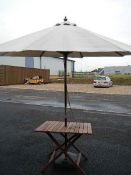 A mahogany garden table with parasol.