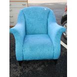 A blue fabric arm chair in good clean condition.