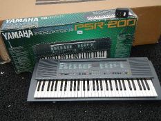 A Yamaha Porta Tone PSR-200 keyboard with power supply.