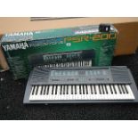 A Yamaha Porta Tone PSR-200 keyboard with power supply.