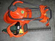 A Black & Decker hedge trimmer and a Flymo micro lite hover mower.