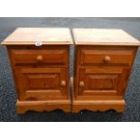 A pair of pine bedside cabinets.