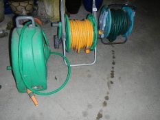 3 long hose pipes on reels.