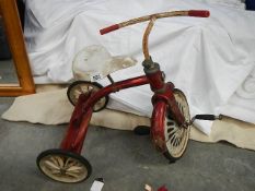 A vintage child's tricycle, possibly Raleigh.