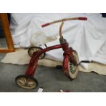 A vintage child's tricycle, possibly Raleigh.