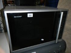 A Sharp R959M-A microwave with grill and convention oven in very clean condition with instruction