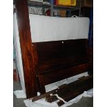 A darkwood bed frame and mattress in good clean condition.