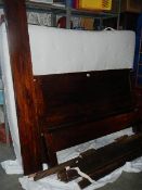 A darkwood bed frame and mattress in good clean condition.