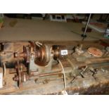 A vintage metal turning lathe in working order.