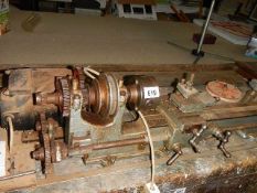 A vintage metal turning lathe in working order.