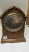 A mahogany inlaid eight day mantel clock.