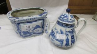 A blue and white teapot together with a blue and white planter.