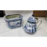 A blue and white teapot together with a blue and white planter.