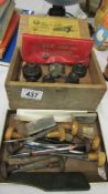 A boxed set of sheet metal punches and other metal working tools.