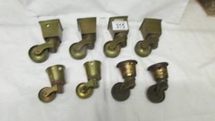 A set of four brass furniture caster for square legs and 4 others.