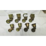 A set of four brass furniture caster for square legs and 4 others.