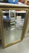 A gilt framed mirror.