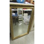 A gilt framed mirror.