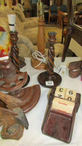 Two wooden table lamp bases, a pair of wooden candlestick, a pipe rack,