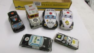 Six vintage tin plate police cars.