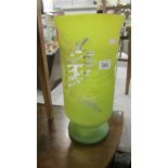 A tall yellow glass vase.