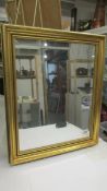 A bevel edged gilt framed mirror, 60 x 50 cm (Collect only).