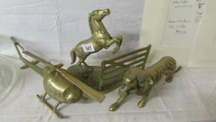 A brass horse, a brass tiger and a brass helictopter.