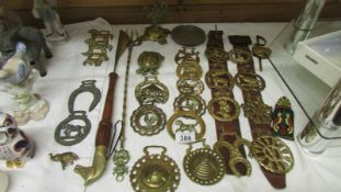 A good lot of horse brasses, toasting fork, shoe horn etc.