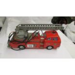 A Japanese tin plate 'Modern Toys' battery operated fire engine (no battery hand control).