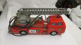 A Japanese tin plate 'Modern Toys' battery operated fire engine (no battery hand control).