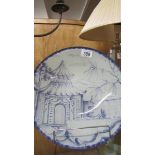 A blue and white glass bowl with oriental scene.