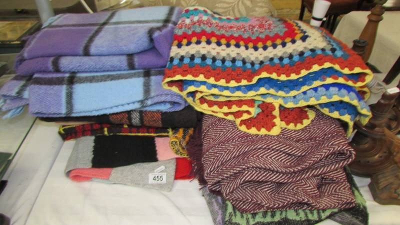 A mixed lot of knitted, crocheted and wool blankets.