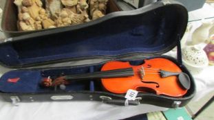 A cased child's violin.