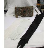 A vintage handbag with feather front and three pairs of vintage gloves.