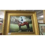 A gilt framed print of a racehorse.