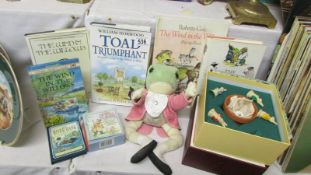 A quantity of Wind in the Willow books, a soft toy frog and a Beatrix Potter board game.
