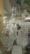 Three cut glass decanters.