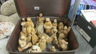 An old suitcase containing various corn dollies.