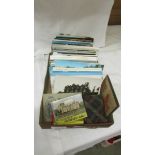 A box of assorted postcards.