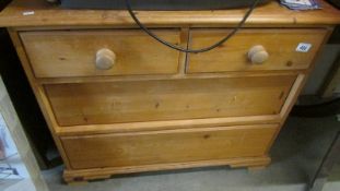 A pine two over two chest of drawers.