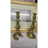 A pair of brass candlesticks.