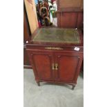 A record player in a mahogany cabinet.